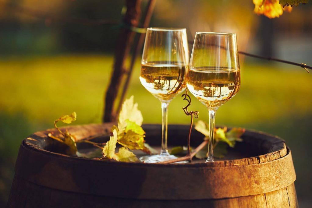 White wine glasses on a barrel